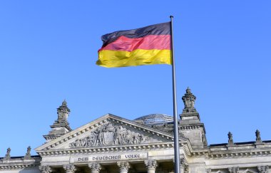 The German flag flying in front of the Reichstag in Berlin clipart