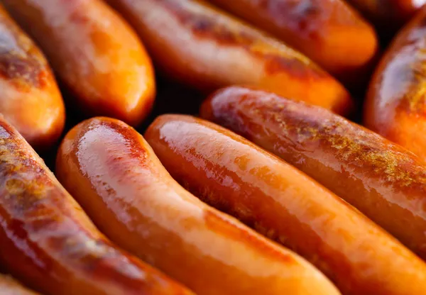 Sausages frying — Stock Photo, Image