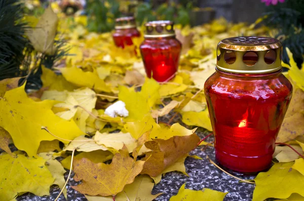 Red votive candle on graveyrd — Stock Photo, Image