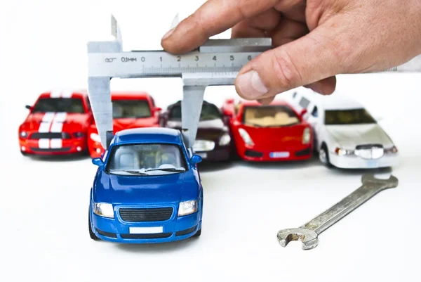 Five cars and hands with measure — Stock Photo, Image