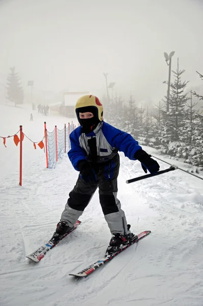 Photo of boy on skies on ski lift — Stock Photo, Image