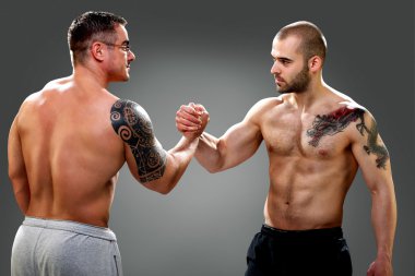 Two musculine guys making an agreement clipart