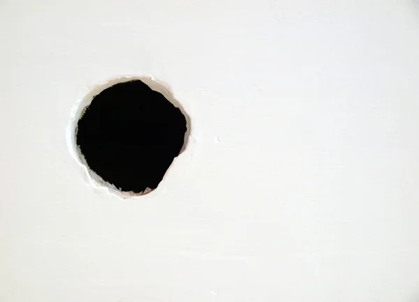 Hole on the white wall Stock Photo