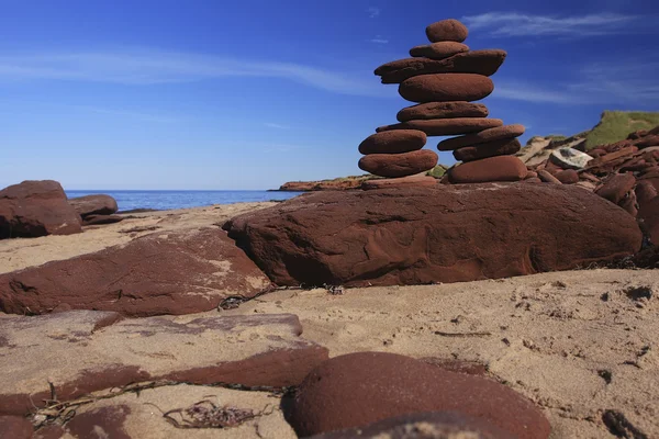 Inukshuk made of Red rocks Stock Picture