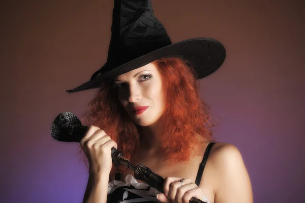 Sexy redheaded witch Stock Photo