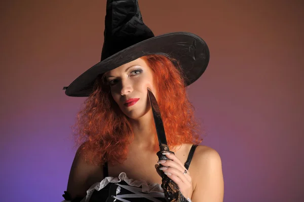 Sexy redheaded witch Stock Image