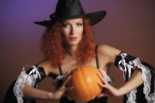 Beautiful red-haired witch Stock Image