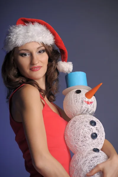Jonge vrouw met een sneeuwpop — Stockfoto