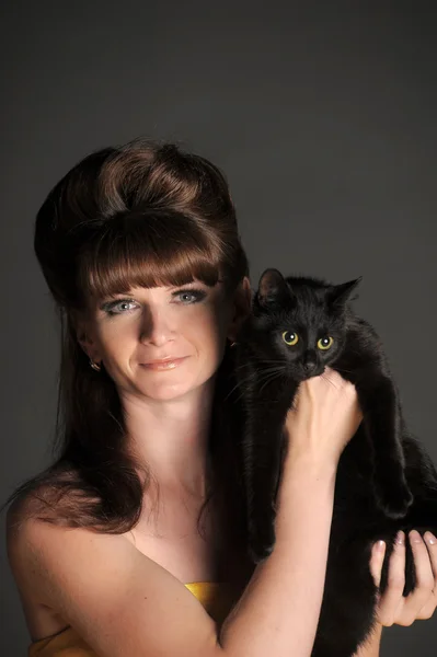 Woman with a black cat — Stock Photo, Image