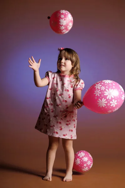 Little girl with balloons — Stock Photo, Image