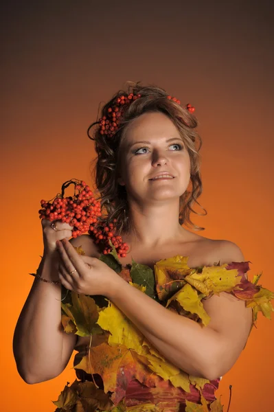 Beautiful girl holds a branch of a mountain ash — Stok fotoğraf