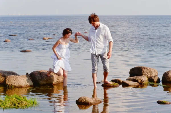 Unga romantiska par går på vatten — Stockfoto