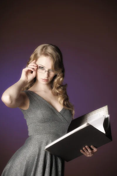 Attractive blonde secretary in a gray dress — Stock Photo, Image
