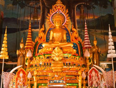 Golden buddha statue inside a temple in Ubonratchathani, Thailan clipart