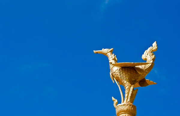 stock image Thai style golden bird statue in blue sky