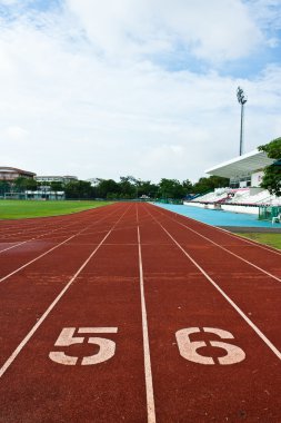 Number five and six on the start of a running track clipart