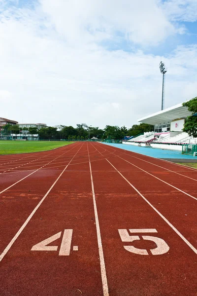 Número cuatro y cinco al inicio de una pista de atletismo — Foto de Stock