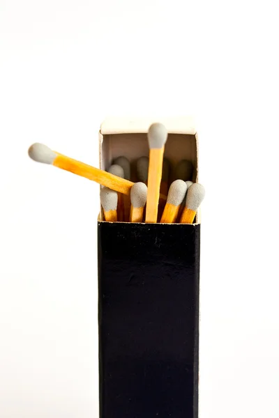 Cabeça cinza corresponde com caixa no fundo branco — Fotografia de Stock