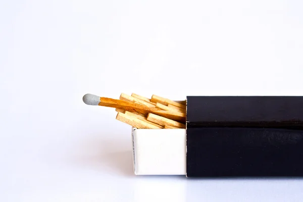 stock image Gray head matches with box on white background