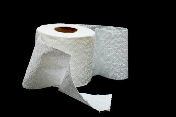 stock image Roll of white toilet paper on a black background.