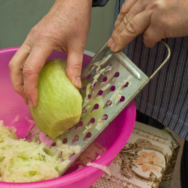 Preparation of green radish salad. clipart