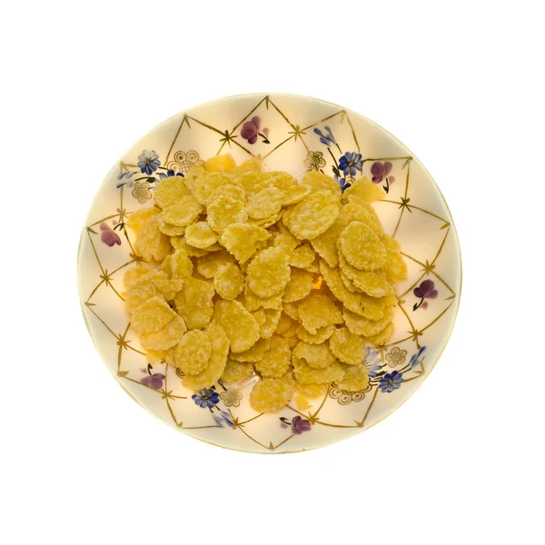 Fiocchi di mais in un piatto su sfondo bianco . — Foto Stock