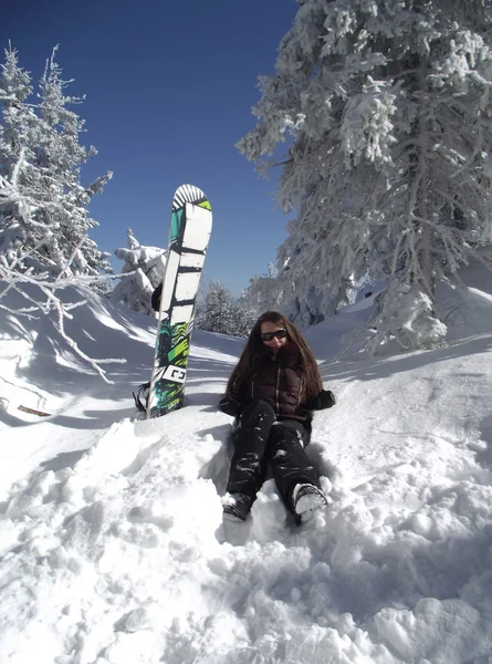 Mujer joven con una tabla de snowboard —  Fotos de Stock