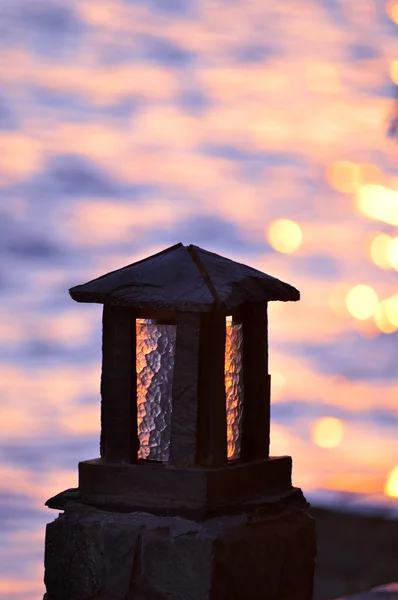 Каменная лампа на берегу моря — стоковое фото