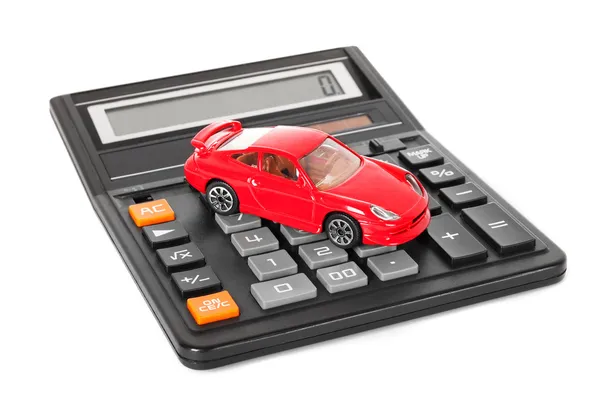 Taschenrechner und rotes Spielzeugauto — Stockfoto