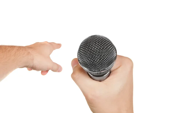 Microfone em uma mão e outra mão apontando para a frente — Fotografia de Stock