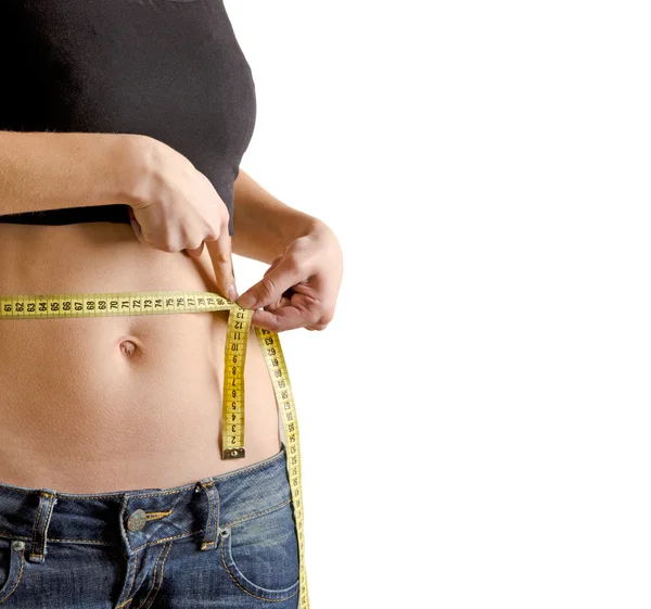 Woman measuring waistline with a tape — Stock Photo, Image