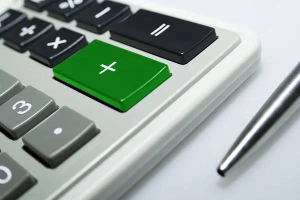 Calculator and pen on white background. — Stock Photo, Image