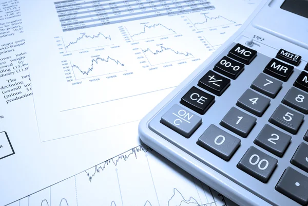 Calculator and financial data with graphs. Business concept. — Stock Photo, Image