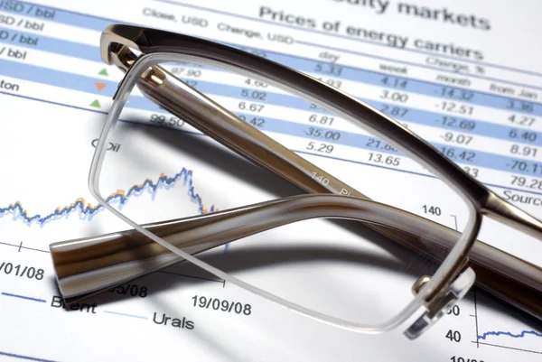 Glass of eyewear and financial report macro. — Stock Photo, Image