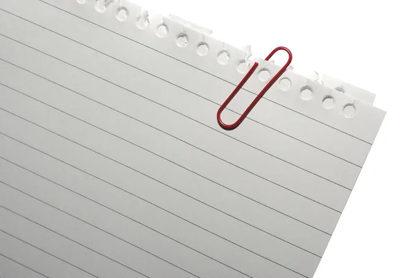 Corner of blank note paper with red paper-clip. Isolated on whit — Stock Photo, Image