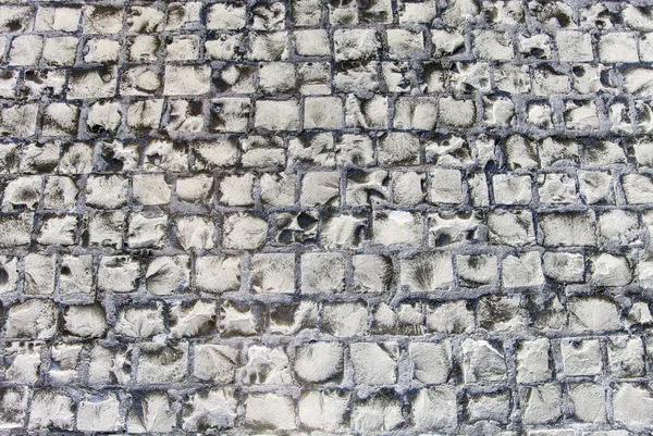Oude weg gemaakt van stenen bakstenen. abstracte textuur achtergrond. — Stockfoto