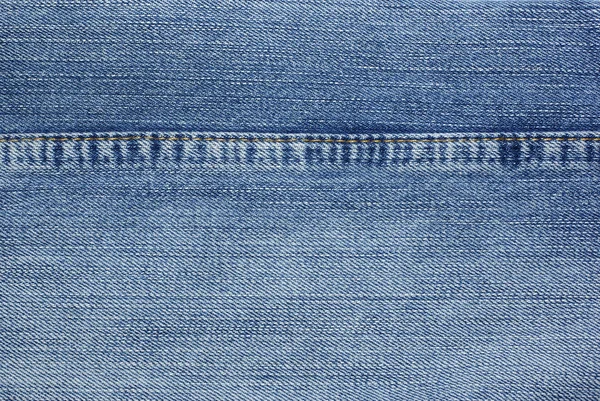 Blue jeans met gele steken achtergrond. — Stockfoto
