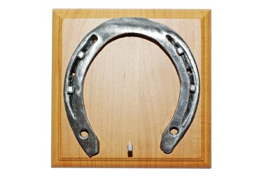 Horseshoe and woode base with nail isolated on white background. clipart