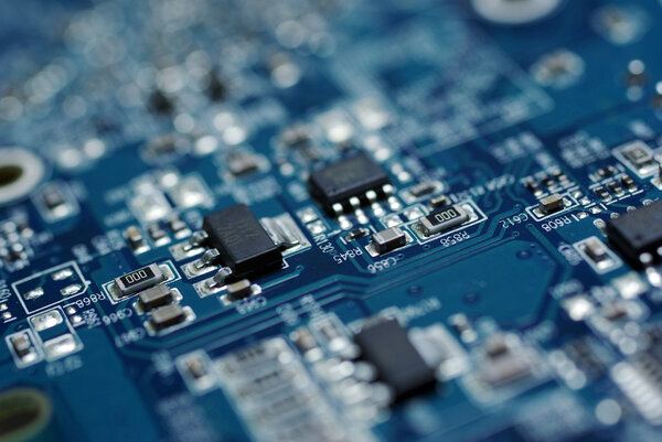 Close up photo of blue PC circuit board.