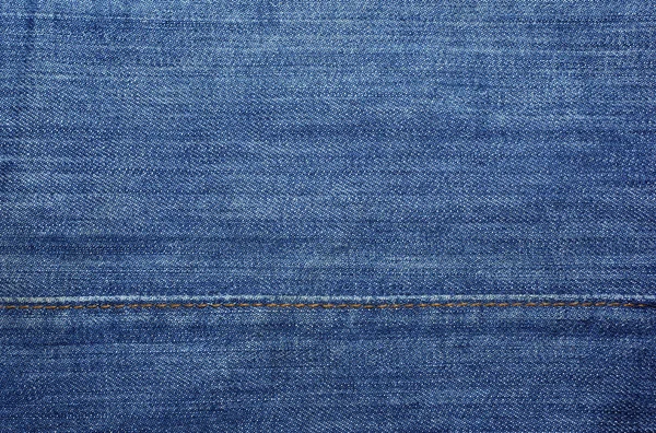 Blue jeans with yellow stitches as textile abstract backdrop or — Stock Photo, Image