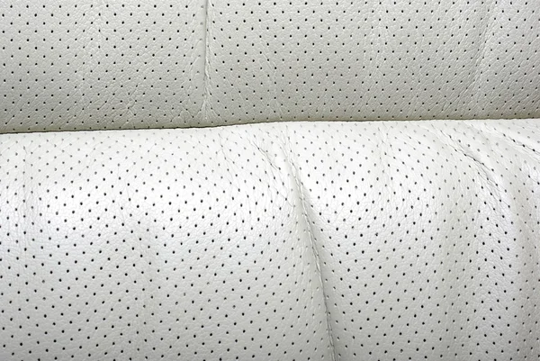 High quality perforated beige car leather textured background. — Stock Photo, Image