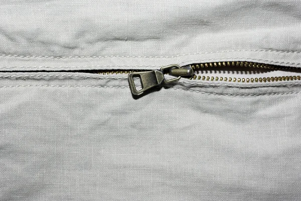 Horizontal textured denim cloth with metallic zipper backdrop. — Stock Photo, Image