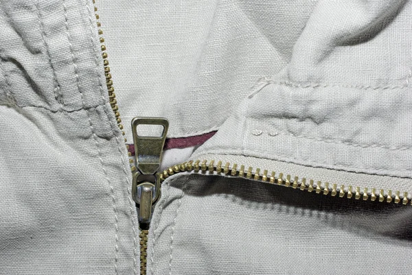 Abstrato tecido jeans bege com zíper fundo . — Fotografia de Stock