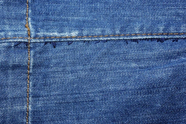 Blue jeans met gele steken abstract textiel achtergrond. — Stockfoto
