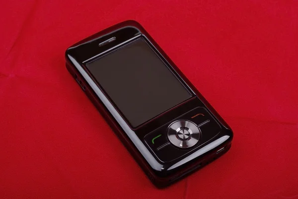 Telefono pda di lusso nero isolato su sfondo rosso . — Foto Stock