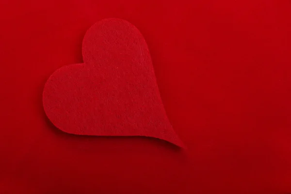 Red textile heart isolated on red background. Empty space for yo — Stock Photo, Image