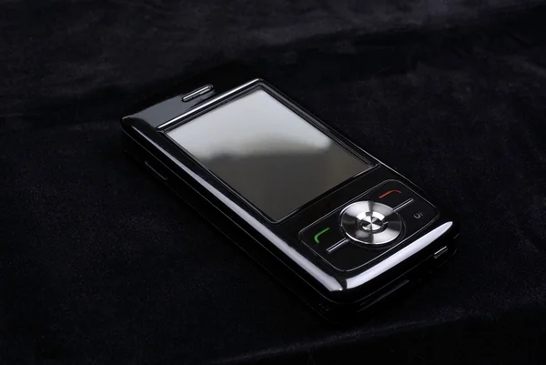 Luxo brilhante pda telefone isolado no fundo de veludo preto . — Fotografia de Stock