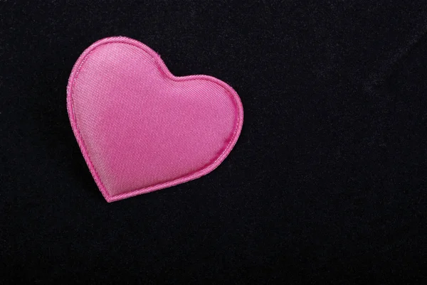 Pink heart macro isolated on black velvet background. Empty spac — Stock Photo, Image