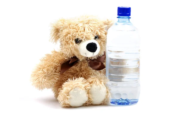 Teddy bear likes natural mineral water. Concept isolated on whit — Stock Photo, Image