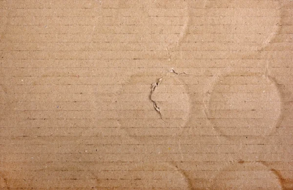 Brown damaged cardboard with bottle traces as background. — Stock Photo, Image